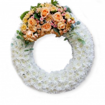 Poza Coroana funerara rotunda din crizanteme si mix de flori portocalii
