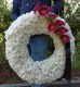  Coroana funerara rotunda din crizanteme albe si gerbera rosu purpuriu